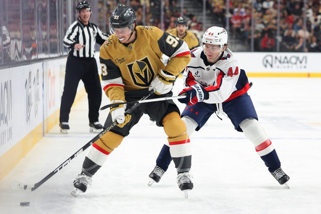 Vegas Golden Knights right wing Mitch Marner (93) skates against Washington Capitals defenseman Cole Hutson (44) during the second period of an NHL hockey game Saturday, March 28, 2026, in Las Vegas. (AP Photo/Ian Maule)
