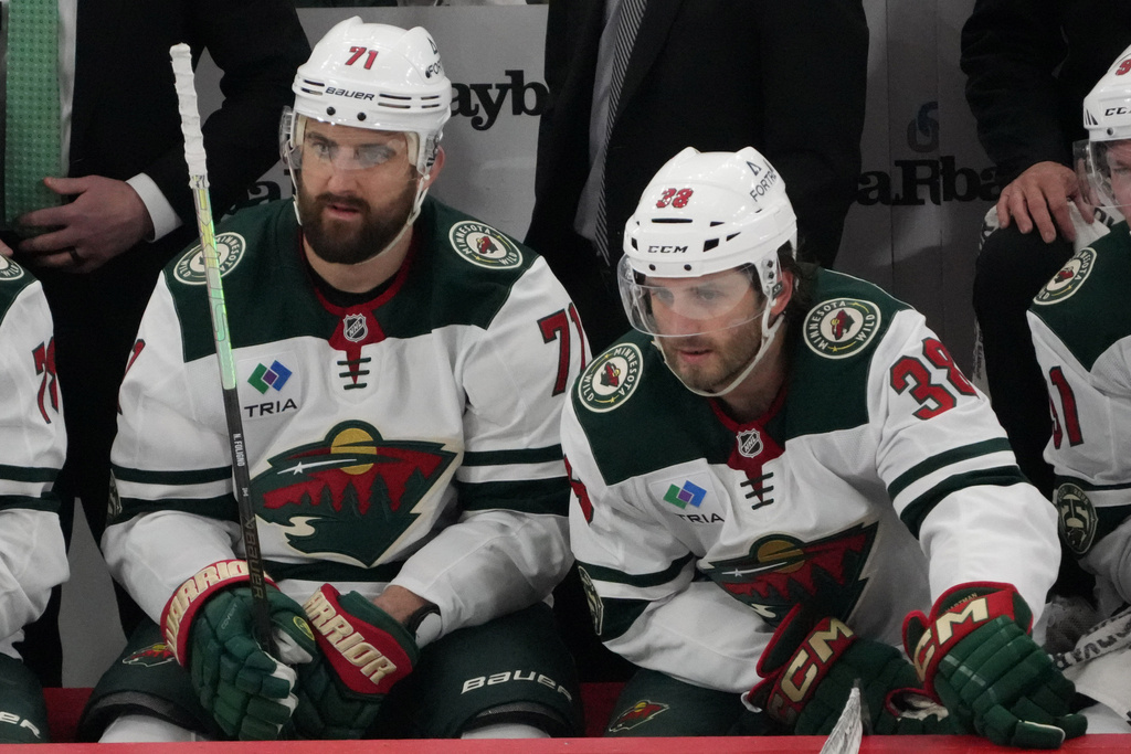 Minnesota Wild left wing Nick Foligno (71) on the bench with Minnesota Wild right wing Ryan Hartman (38) against the Chicago Blackhawks during the third period of an NHL hockey game Tuesday, March, 17, 2026, in Chicago. (AP Photo/David Banks)