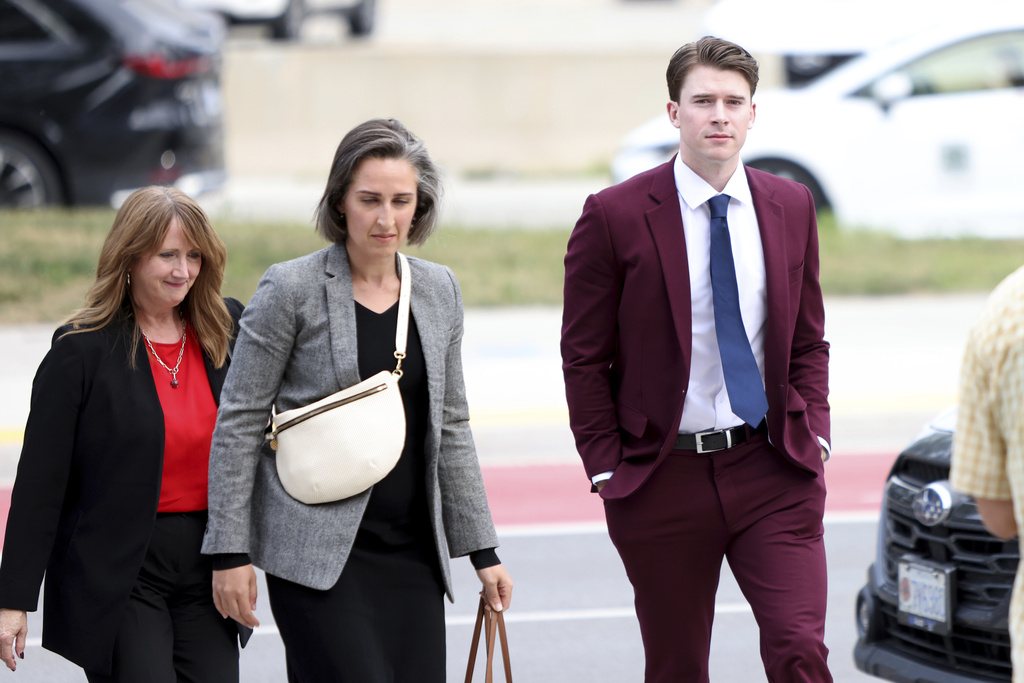 FILE - Hockey player Carter Hart, right, arrives at the London Courthouse in London, Ontario, Thursday, July 24, 2025. (Nicole Osborne/The Canadian Press via AP, File)
