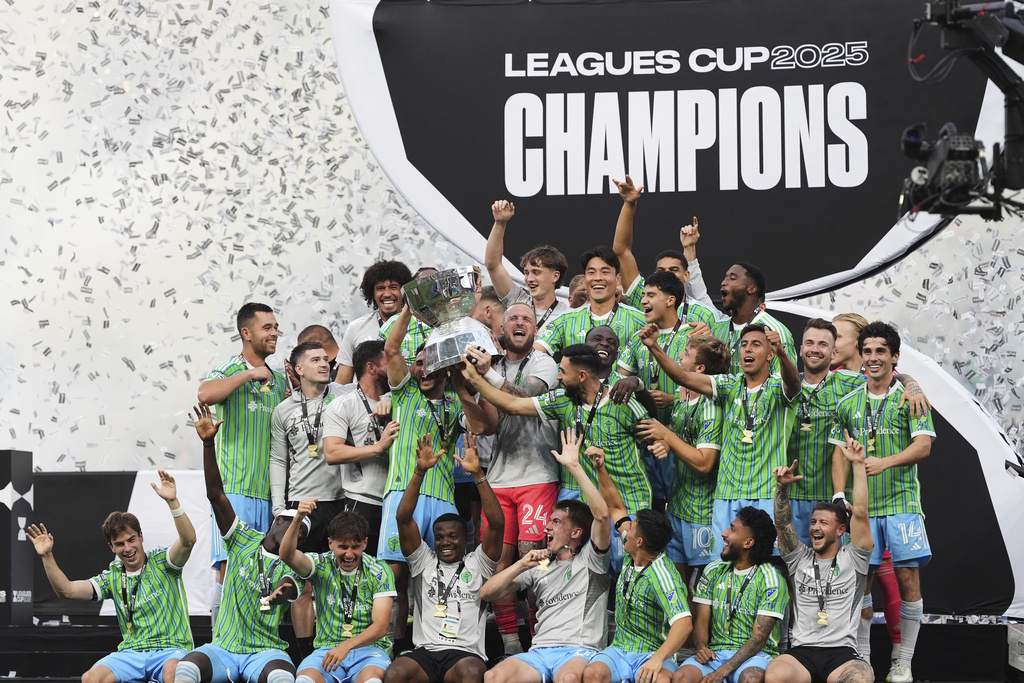 The Seattle Sounders lift the trophy as they celebrate beating Inter Miami in a Leagues Cup final soccer match Sunday, Aug. 31, 2025, in Seattle. (AP Photo/Lindsey Wasson)