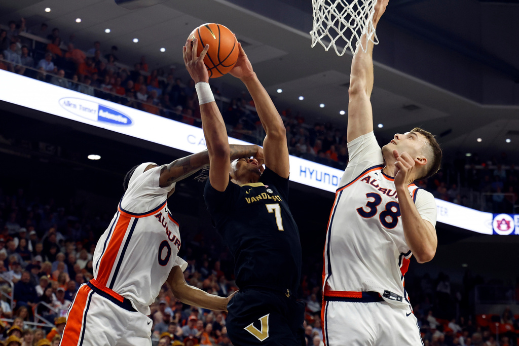 Vanderbilt guard Chandler Bing (7) is fouled by Auburn guard Tahaad Pettiford (0) as he goes up for a shot during the first half of an NCAA college basketball game, Tuesday, Feb. 10, 2026, in Auburn, Ala. (AP Photo/Butch Dill)