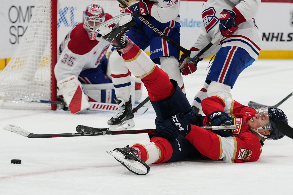 Florida Panthers center Anton Lundell falls to the ice during the second period of an NHL hockey game against the Montréal Canadiens, Tuesday, Dec. 30, 2025, in Sunrise, Fla. (AP Photo/Lynne Sladky)