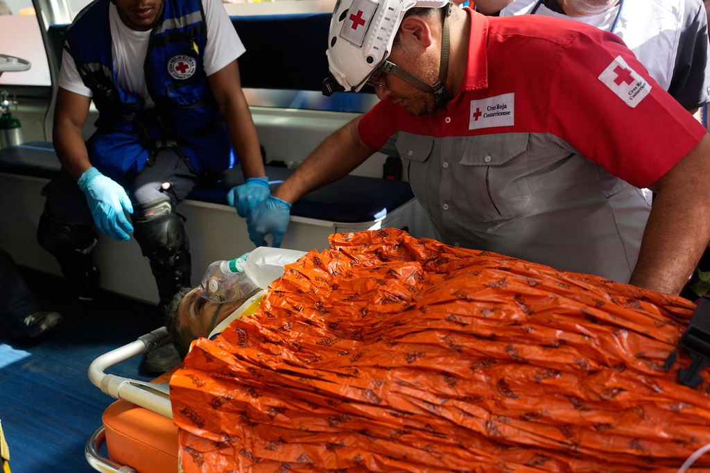 Rescue workers carry Hernán Alberto Gil Flores after he was pulled from the rubble eight days after he was trapped by twin earthquakes that struck Catia La Mar, Venezuela, Thursday, July 2, 2026. (AP Photo/Fernando Vergara)