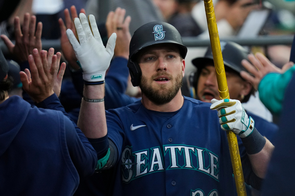 Seattle Mariners' Luke Raley celebrates after hitting a grand slam during the third inning of a baseball game against the Chicago White Sox, Friday, May 8, 2026, in Chicago. (AP Photo/Erin Hooley)