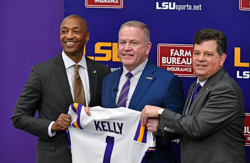 LSU head coach Brian Kelly, center, stands with school president William F. Tate IV, left, and athletic director Scott Woodward, right, as he is introduced during an NCAA college football news conference Dec. 1, 2021, in Baton Rouge, La. (Hilary Scheinuk/The Advocate via AP) LSU head coach Brian Kelly, center, stands with school president William F. Tate IV, left, and athletic director Scott Woodward, right, as he is introduced during an NCAA college football news conference Dec. 1, 2021, in Baton Rouge, La. (Hilary Scheinuk/The Advocate via AP)