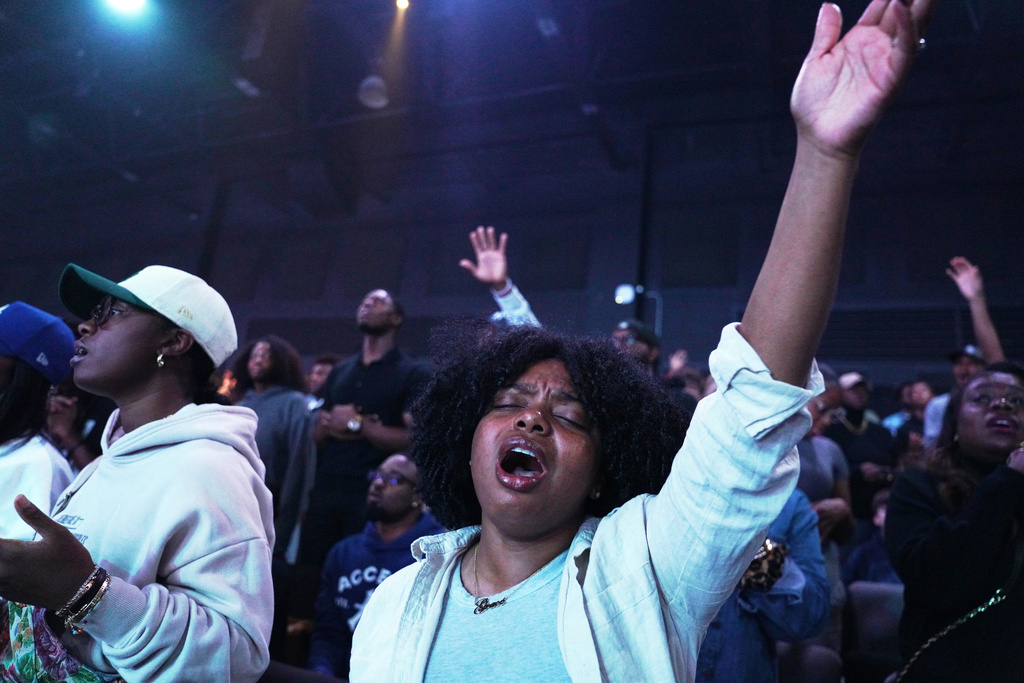 A churchgoer lifts her arm in worship at 2819 Church on Nov. 16, 2025, in Atlanta. (AP Photo/Jessie Wardarski)