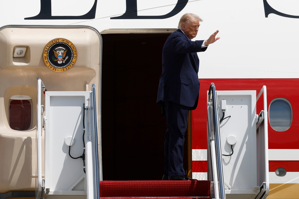 President Donald Trump waves from the stairs of Air Force One at Joint Base Andrews, Md., Tuesday, Aug. 4, 2026.(AP Photo/Luis M. Alvarez)