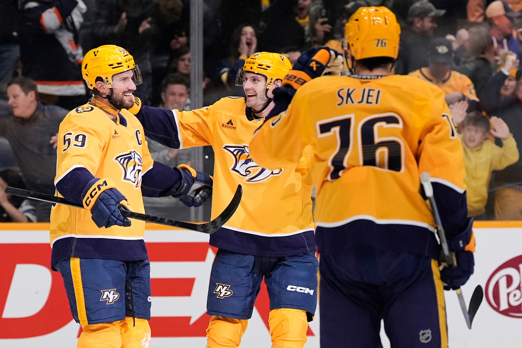 Nashville Predators defenseman Roman Josi (59) is congratulated by left wing Cole Smith (36) and defenseman Brady Skjei (76) after scoring the game winning goal in overtime of an NHL hockey game against the Edmonton Oilers, Tuesday, Jan. 13, 2026, in Nashville, Tenn. (AP Photo/George Walker IV)