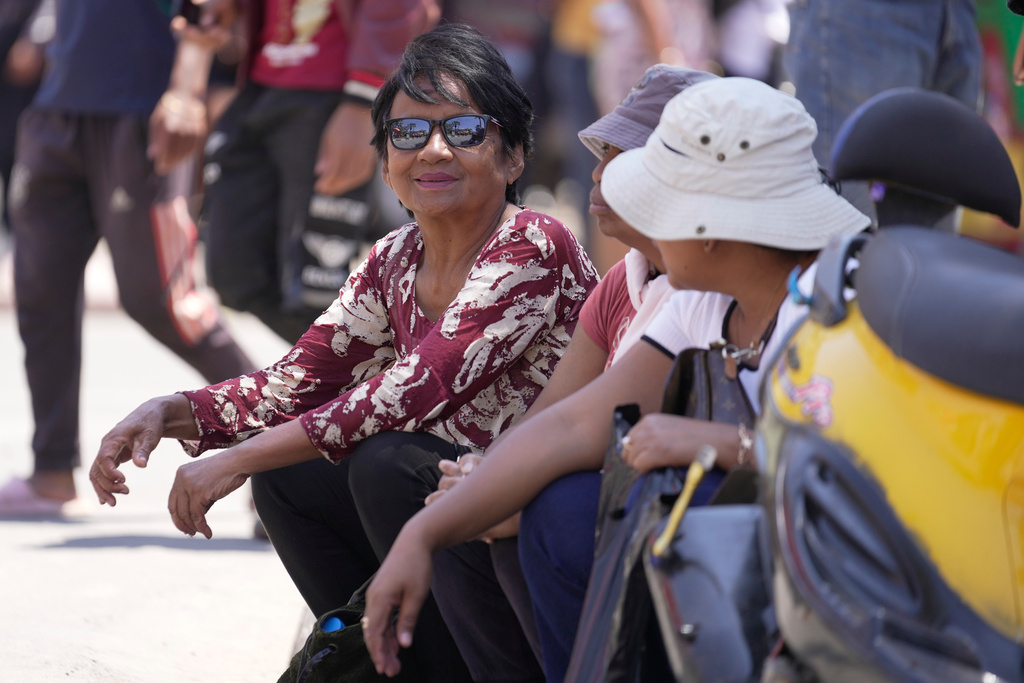 Farasoa Rakotomanana, a 63-year-old unemployed woman, sits on a pavement during a gathering at May 13 Square in Antananarivo, Madagascar, Saturday Oct. 18, 2025. (AP Photo/Brian Inganga)