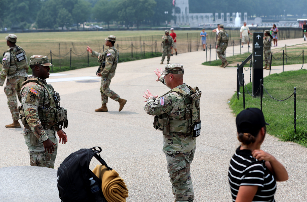 Members of the National Guard patrol around the Washington Monument, before Marine One, with President Donald Trump aboard, departs near the White House, Friday, July 17, 2026, in Washington. (AP Photo/Rahmat Gul)