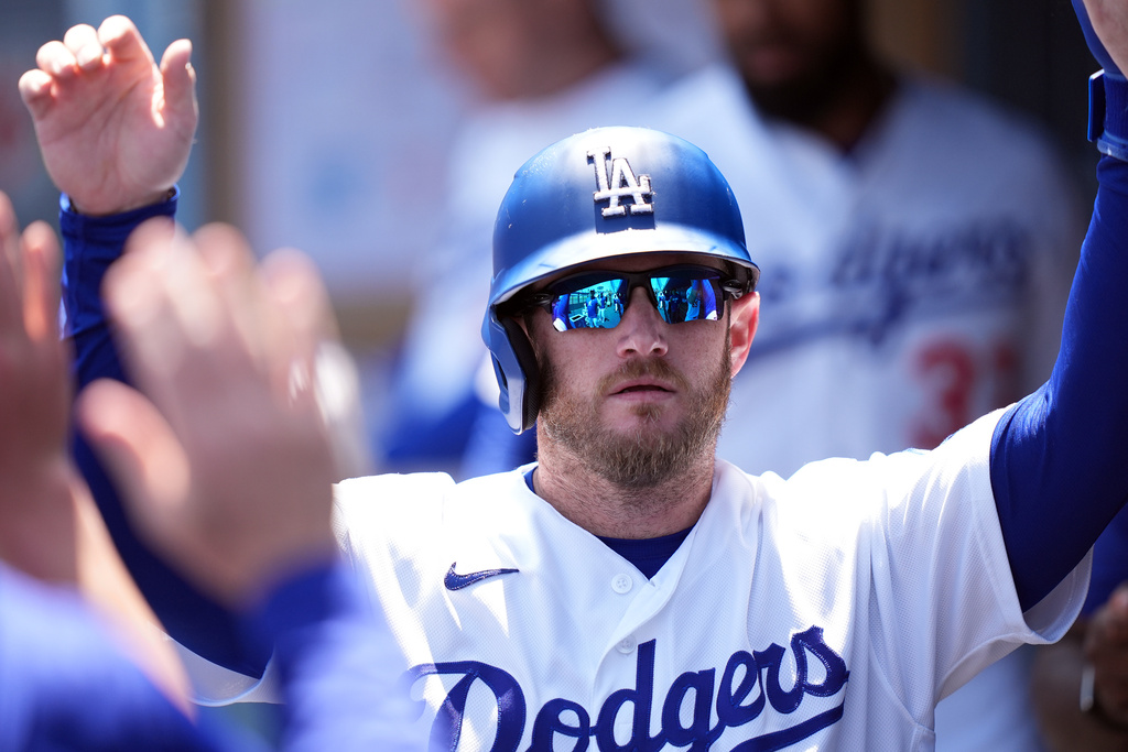 Los Angeles Dodgers' Max Muncy (13) returns to the dugout after scoring on Alex Call's infield single during the third inning of a baseball game against Miami Marlins, Wednesday, April 29, 2026, in Los Angeles. (AP Photo/Scott Strazzante)