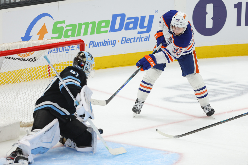 Utah Mammoth goaltender Vitek Vanecek (41) stops the puck against Edmonton Oilers center Ryan Nugent-Hopkins (93) during the third period of an NHL hockey game, Tuesday, March 24, 2026, in Salt Lake City. (AP Photo/Melissa Majchrzak)