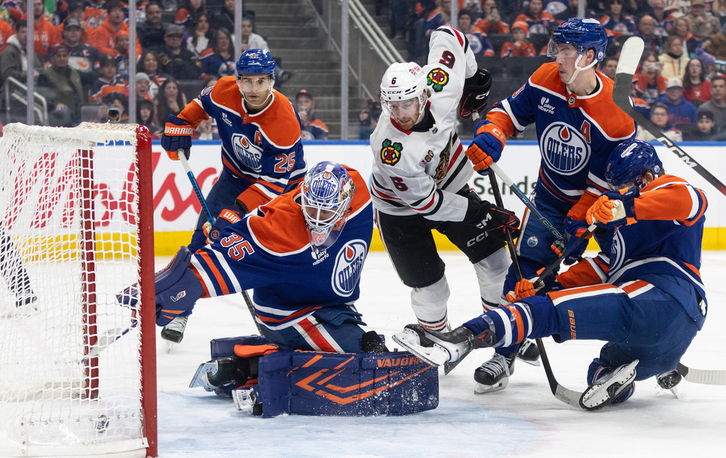 Chicago Blackhawks' Sam Rinzel (6) watches the puck go in past Edmonton Oilers goalie Tristan Jarry (35) during third-period NHL hockey game action in Edmonton, Alberta, Thursday, April 2, 2026. (Jason Franson/The Canadian Press via AP)