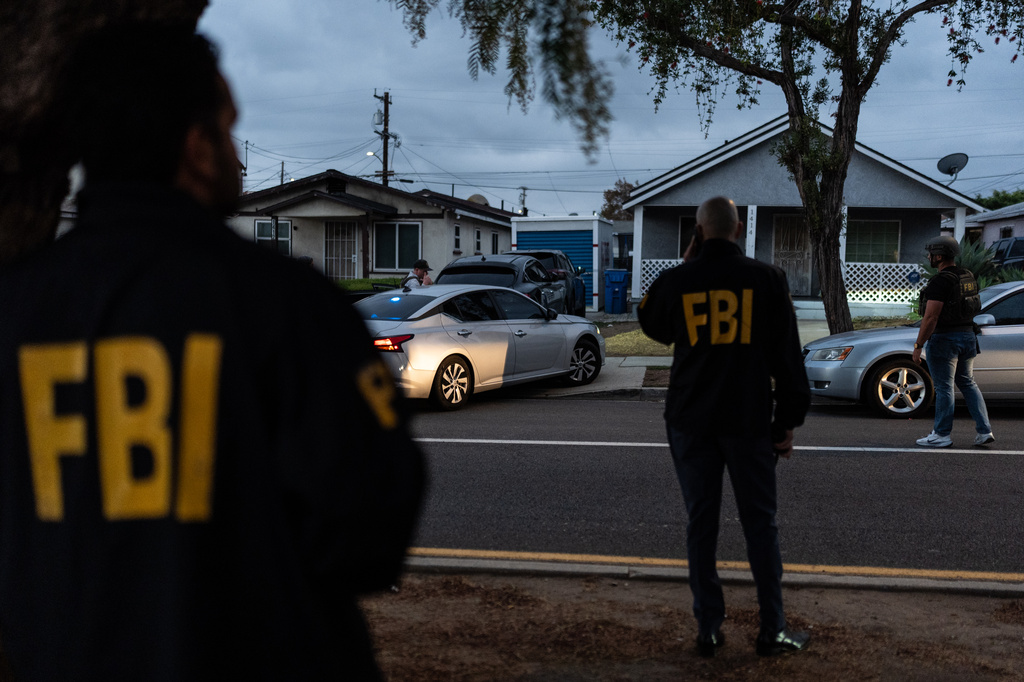 FBI agents stand outside the home of Lakiya Malone, who is charged with fraud involving federal homelessness aid programs, in Los Angeles, Wednesday, Sept. 16, 2026. (AP Photo/Jae C. Hong)