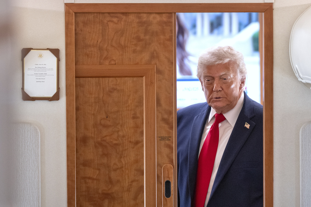 President Donald Trump arrives to speak to reporters aboard Air Force One en route from Joint Base Andrews, Md., to Eau Claire, Wis., Friday, June 5, 2026. (AP Photo/Mark Schiefelbein)