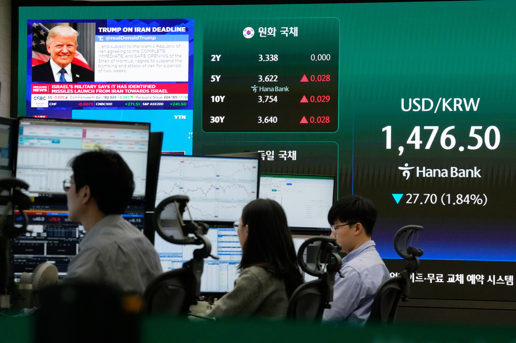 U.S. President Donald Trump is seen on a screen as traders work at the foreign exchange dealing room of the Hana Bank headquarters in Seoul, South Korea, Wednesday, April 8, 2026. (AP Photo/Ahn Young-joon)