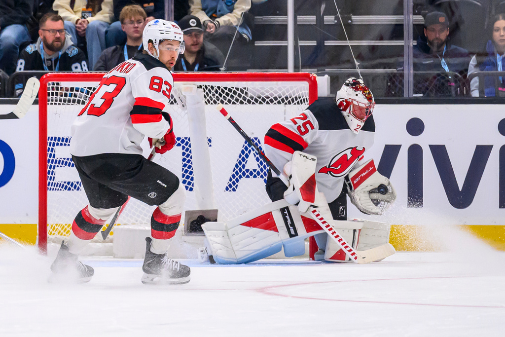 New Jersey Devils goaltender Jacob Markstrom (25) makes a glove-save during the first period of an NHL hockey game against the Utah Mammoth, Friday, Dec. 19, 2025, in Salt Lake City. (AP Photo/Tyler Tate)