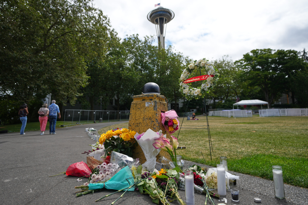 A memorial for victims of a July 26 shooting is seen at Seattle Center during the Bite of Seattle food festival, Tuesday, July 28, 2026, in Seattle. (AP Photo/Lindsey Wasson)