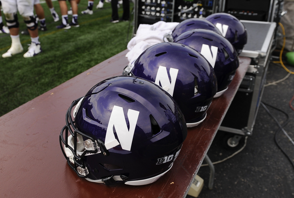 FILE - Northwestern football helmets at an NCAA college football against Stanford in Evanston, Ill, Sept. 5, 2015. (AP Photo/Matt Marton, File)