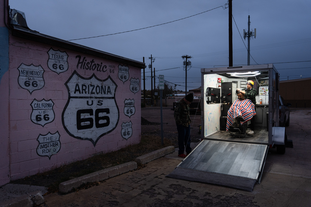 Rana Bal gets a haircut from Daniel Bailon inside a mobile barbershop in Holbrook, Ariz., a town on historic Route 66, Wednesday, Nov. 19, 2025. (AP Photo/Jae C. Hong)