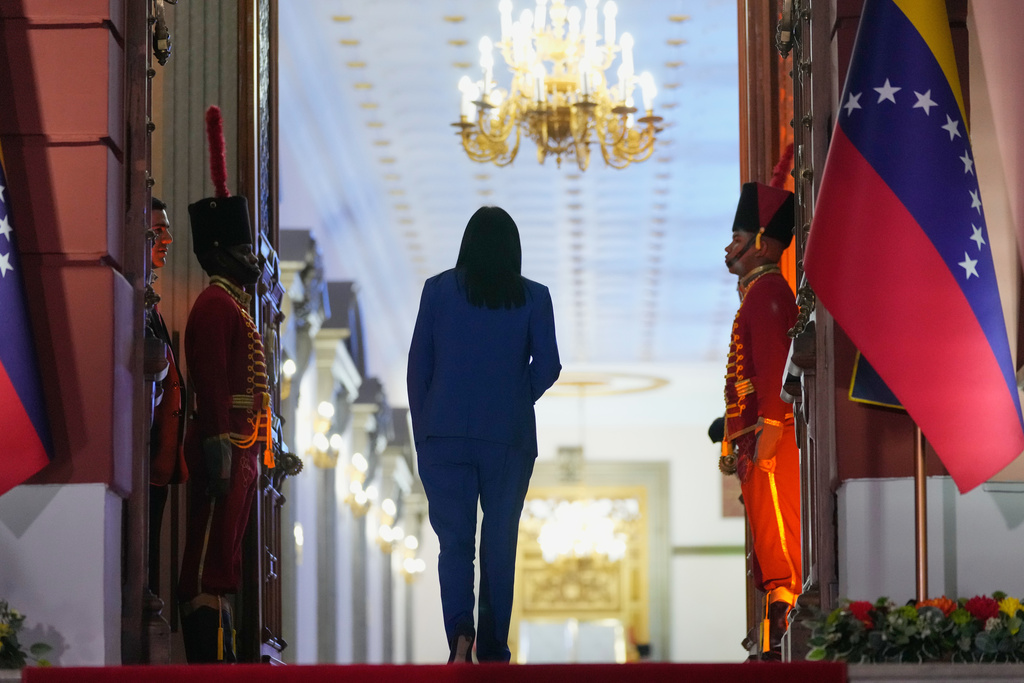 Venezuela's acting President Delcy Rodriguez walks back into Miraflores Palace after signing an amnesty bill approved by the National Assembly in front of journalists in Caracas, Venezuela, Thursday, Feb. 19, 2026. (AP Photo/Ariana Cubillos)