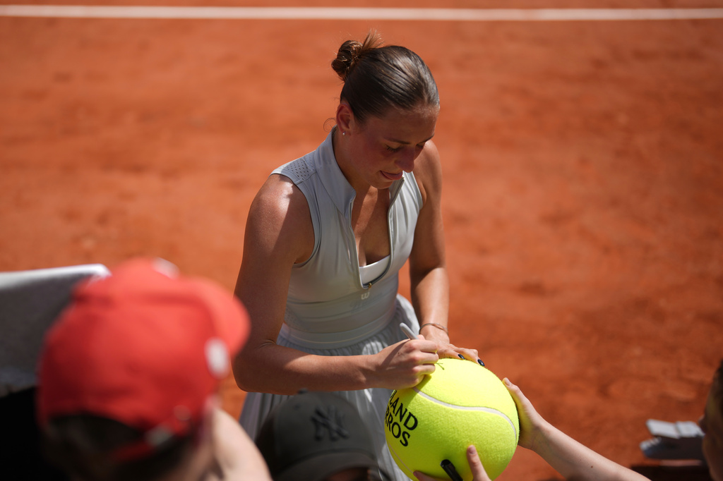 Marta Kostyuk of Ukraine signs autographs after winning against Oksana Selekhmeteva of Spain during their first round women's singles tennis match at the French Open tennis tournament in Paris, Sunday, May 24, 2026. (AP Photo/Thibault Camus)