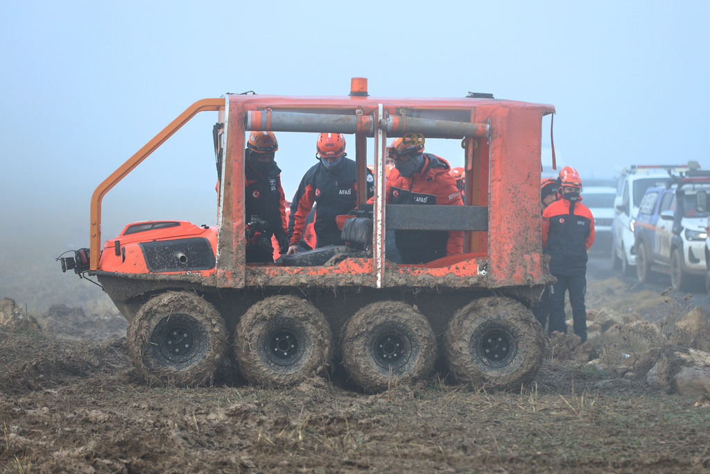 Turkish rescue teams search for the remains of a private jet carrying Libya's military chief and four others that crashed after taking off from Ankara, killing everyone on board, in Ankara, Turkey, early Wednesday, Dec. 24, 2025. (AP Photo/Efekan Akyuz)