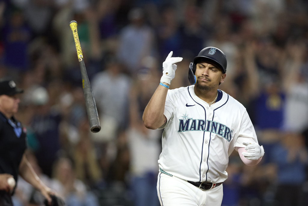Seattle Mariners first baseman Josh Naylor hits a two RBI home run off Chicago White Sox pitcher Bryan Hudson during the seventh inning of a baseball game, Tuesday, Aug. 5, 2025, in Seattle. (AP Photo/John Froschauer)
