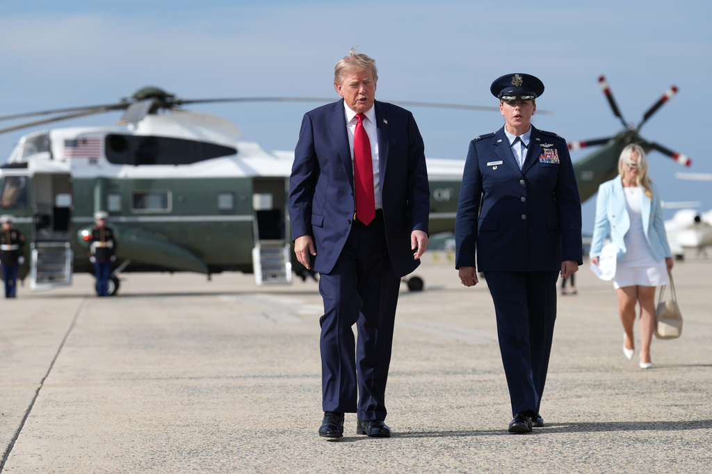 President Donald Trump, left, walks from Marine One to board Air Force One, Friday, Aug. 21, 2026, at Joint Base Andrews, Md., en route to South Carolina. (AP Photo/Jacquelyn Martin)