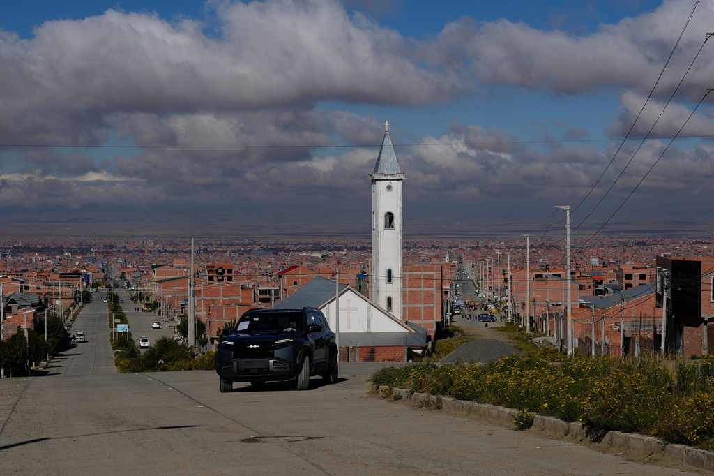 Simón Huanca drives his electric vehicle through the streets of El Alto, Bolivia, Friday, April 24, 2026. (AP Photo/Juan Karita)