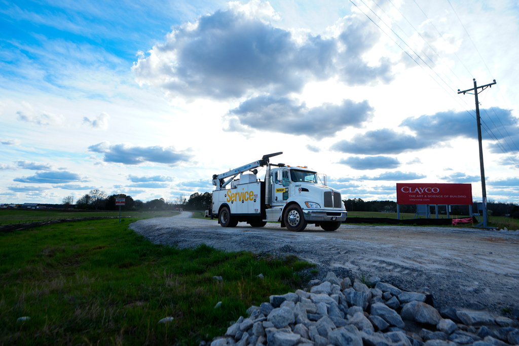 FILE - A truck leaves the site of a planned Rivian electric truck plant Thursday, March 7, 2024, in Social Circle, Ga. (AP Photo/John Bazemore, File)