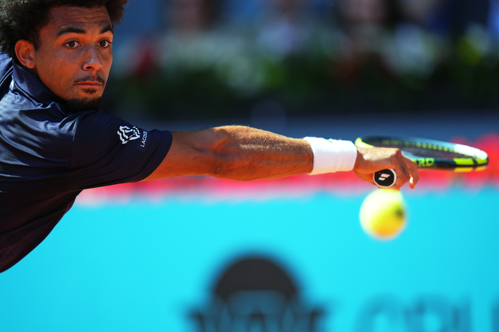 France's Arthur Fils returns the ball to Italy's Jannik Sinner during their men's singles semifinal match at the Madrid Open tennis tournament in Madrid, Spain, Friday, May 1, 2026. (AP Photo/Manu Fernandez)