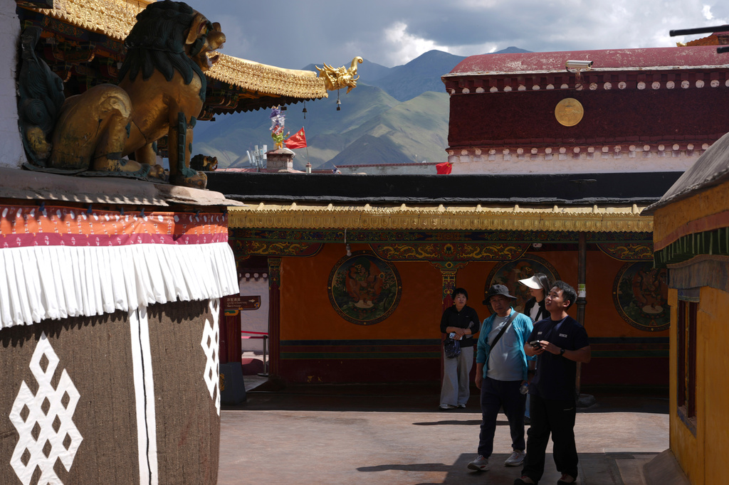 Visitors tour Jokhang Temple in Lhasa in western China's Tibet Autonomous Region on Tuesday, July 21, 2026, as seen during a government organized visit for foreign journalists. (AP Photo/Ng Han Guan)