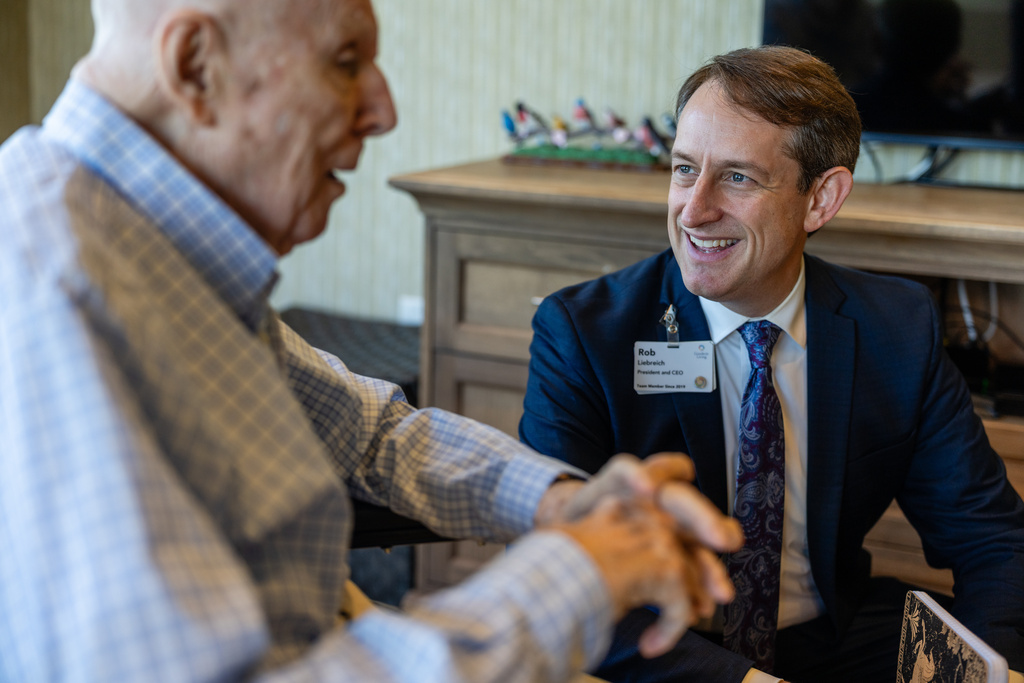 Rob Liebreich, CEO of Goodwin Living, right, checks in with resident Donald Goodness, 92, at Goodwin House Alexandria, Thursday, Oct. 16, 2025, in Alexandria, Va. (AP Photo/Eric Lee)
