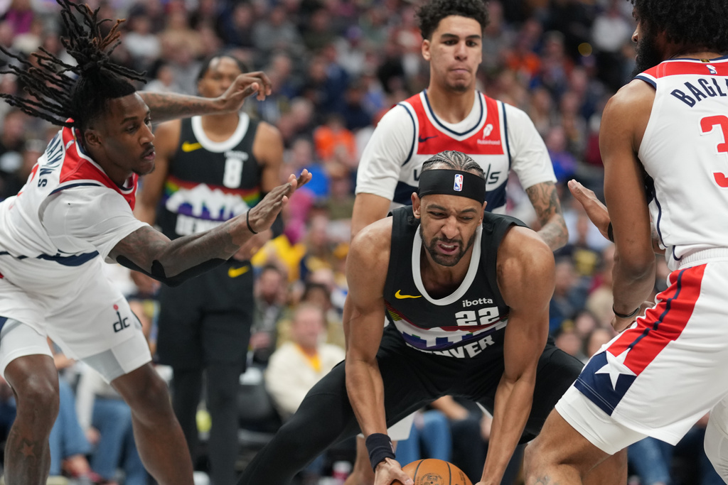 Denver Nuggets forward Zeke Nnaji, center front, pulls in thee ball as, from top left to right, Washington Wizards forwards Jamir Watkins, Will Riley and Marvin Bagley III defend in the second half of an NBA basketball game Saturday, Jan. 17, 2026, in Denver. (AP Photo/David Zalubowski)
