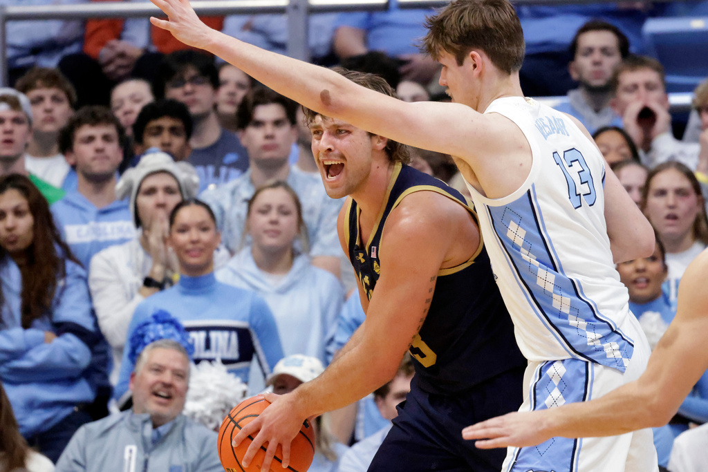 Notre Dame forward Carson Towt, left, is guarded by North Carolina center Henri Veesaar (13) during the first half of an NCAA college basketball game Wednesday, Jan. 21, 2026, in Chapel Hill, N.C. (AP Photo/Chris Seward)