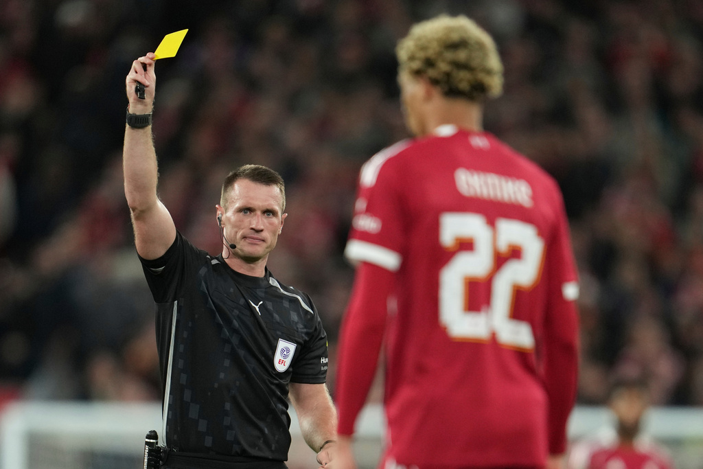 Referee Thomas Bramall shows the yellow card to Liverpool's Hugo Ekitike during the English League Cup third round soccer match between Liverpool and Southampton at the Anfield stadium in Liverpool, England, Tuesday, Sept. 23, 2025. (AP Photo/Jon Super)