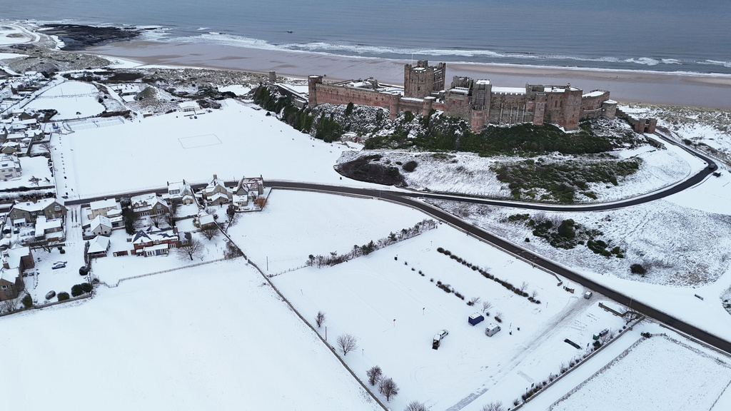 Bamburgh Castle surrounded by snow in Bamburgh, England, Tuesday, Jan. 6, 2026. (Owen Humphreys/PA via AP)