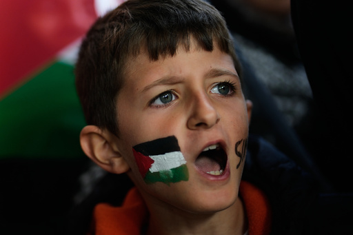 A boy with a Palestinian flag painted on his face chants slogans during a gathering outside Istanbul Airport, as people wait for the arrival of 137 activists from the Global Sumud Flotilla, in Istanbul, Turkey, Saturday, Oct. 4, 2025. (AP Photo/Khalil Hamra) A boy with a Palestinian flag painted on his face chants slogans during a gathering outside Istanbul Airport, as people wait for the arrival of 137 activists from the Global Sumud Flotilla, in Istanbul, Turkey, Saturday, Oct. 4, 2025. (AP Photo/Khalil Hamra)