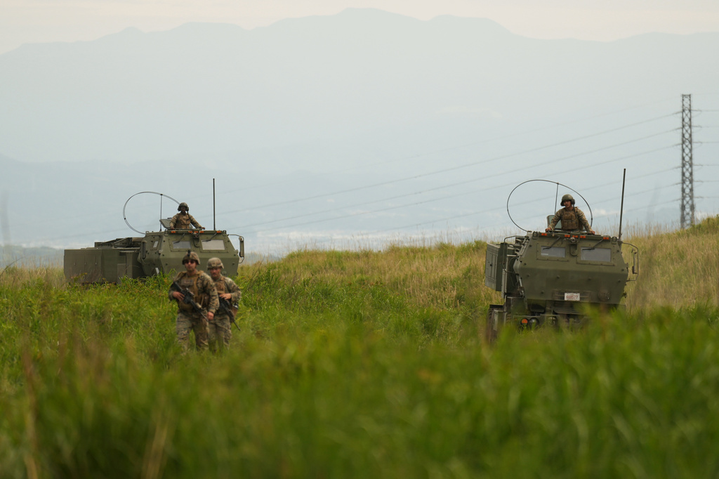 U.S. Marines appear to show the High Mobility Artillery Rocket System (HIMARS) mounted on trucks during a media tour after they conducted its live-fire training at Camp Fuji, in Gotemba, southwest of Tokyo, Wednesday, May 20, 2026. (AP Photo/Hiro Komae)