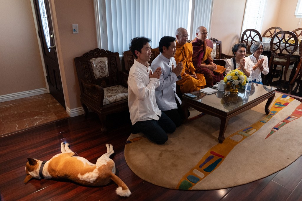 Bhikkhu Pannakara, third from right, a Buddhist monk who led a Walk for Peace from Fort Worth, Texas, to Washington, D.C., poses for a group photo as his dog, Aloka, rests nearby in the North Hollywood section of Los Angeles, Monday, July 13, 2026. (AP Photo/Jae C. Hong)