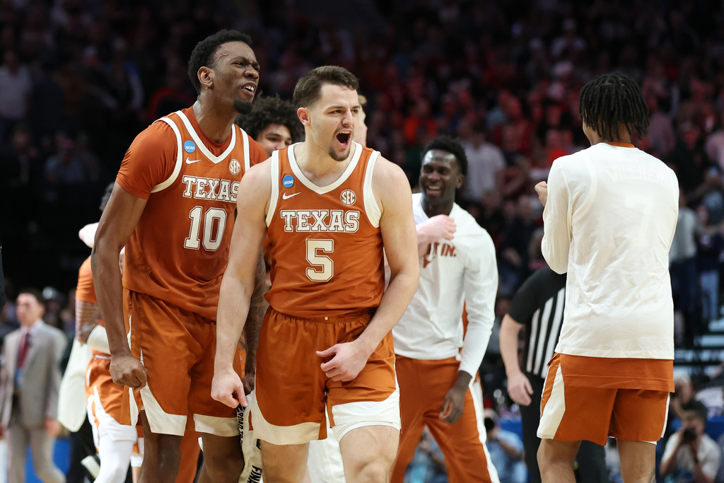 Texas forward Camden Heide (5) celebrates with forward Nic Codie (10) after the second round of the NCAA college basketball tournament against Gonzaga, Saturday, March 21, 2026, in Portland, Ore. (AP Photo/Amanda Loman)