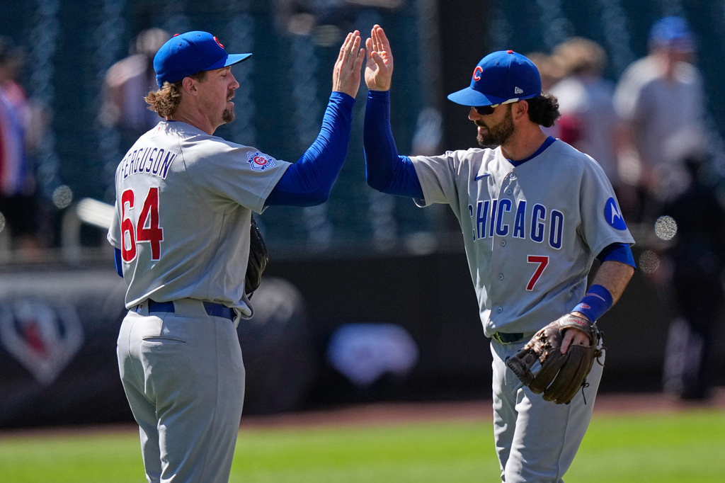 Chicago Cubs' Dansby Swanson (7) celebrates with Tyler Ferguson (64) after the first baseball game of a doubleheader against the New York Mets Wednesday, June 24, 2026, in New York. (AP Photo/Frank Franklin II)