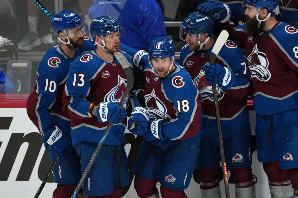 Colorado Avalanche center Jack Drury, center, is congratulated by, from left, center Nicolas Roy, right wing Valeri Nichushkin, and defensemen Devon Toews and Brent Burns in the third period of Game 5 of an NHL Stanley Cup hockey second-round playoff series against the Minnesota Wild Wednesday, May 13, 2026, in Denver. (AP Photo/David Zalubowski)