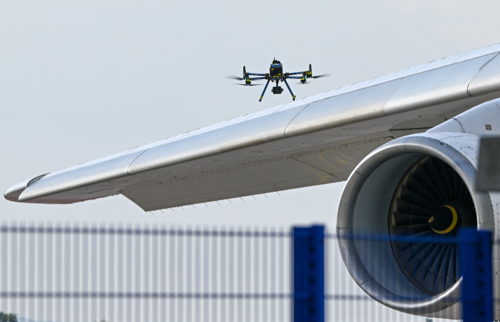 A police drone checks an aircraft at Leipzig/Halle Airport, where a drone with an explosive device was found and a detonator was removed from the object, in Schkeuditz, Germany, Wednesday Aug. 5, 2026. (Hendrik Schmidt/dpa via AP)