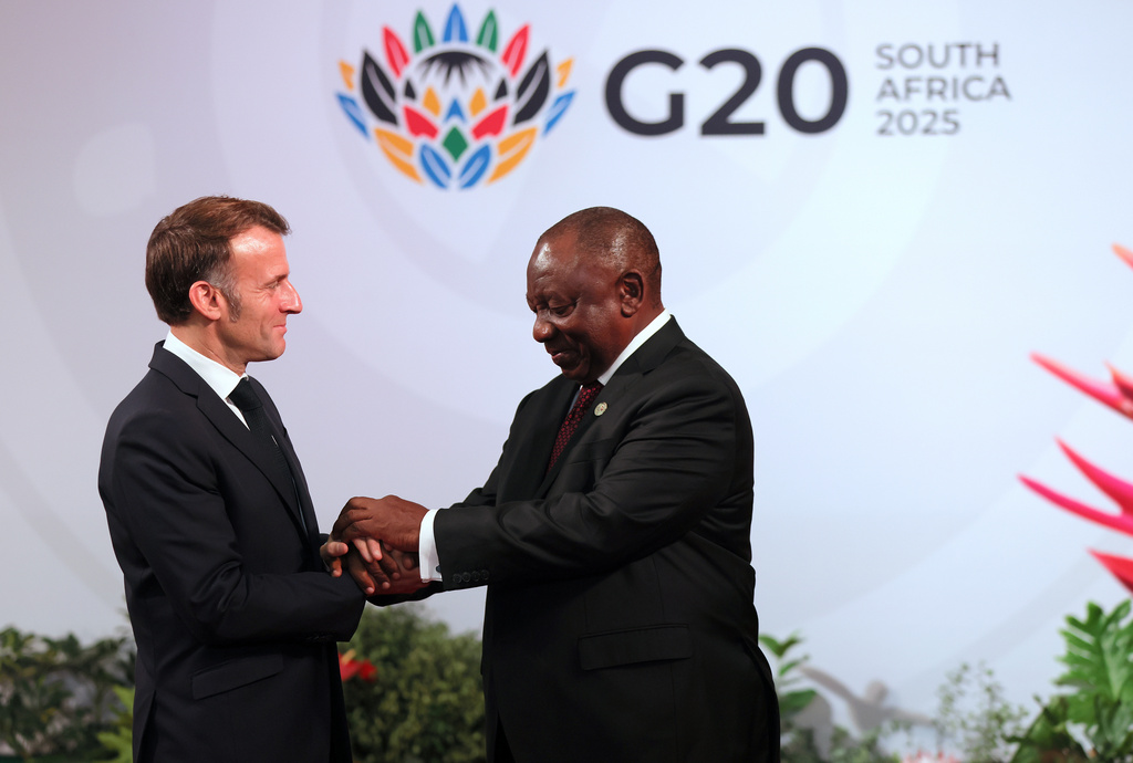 FILE - South African President Cyril Ramaphosa, right, welcomes French President Emmanuel Macron on the opening day of the G20 Summit in Johannesburg, South Africa, Saturday, Nov. 22, 2025. (Halden Krog/Pool Photo via AP, File)
