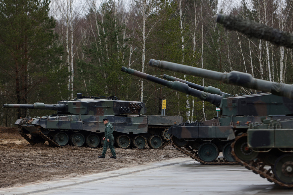 FILE - A Polish soldier walks next to the Leopard 2 tanks during a training at a military base and test range in Swietoszow, Poland, Monday, Feb. 13, 2023. (AP Photo/Michal Dyjuk, File)