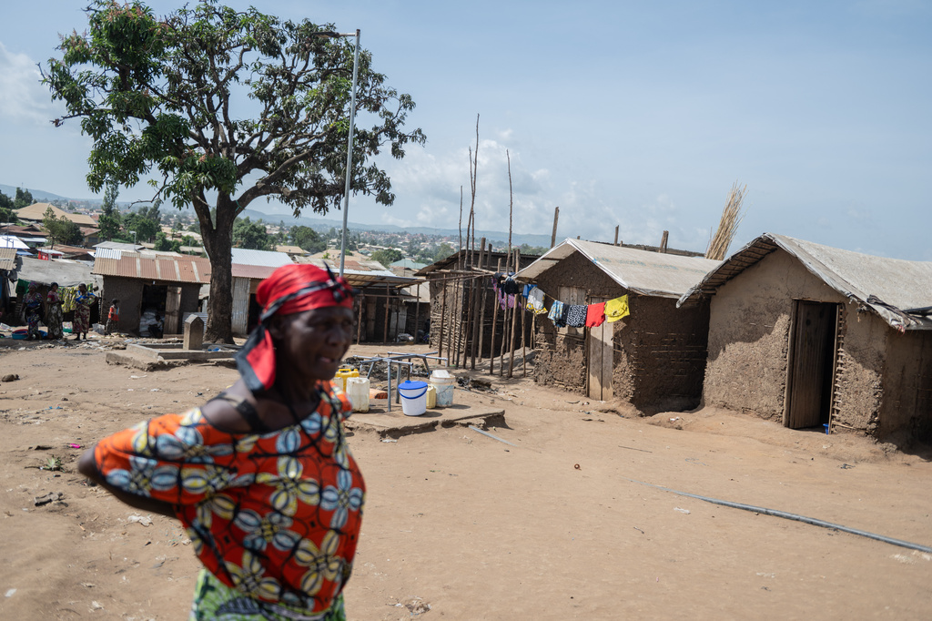A woman walks in the camp on the property of the city's ISP (Institut Supérieur Pédagogique) where internally displaced people reside in Bunia, Congo, Tuesday, May 26, 2026. (AP Photo/Moses Sawasawa)
