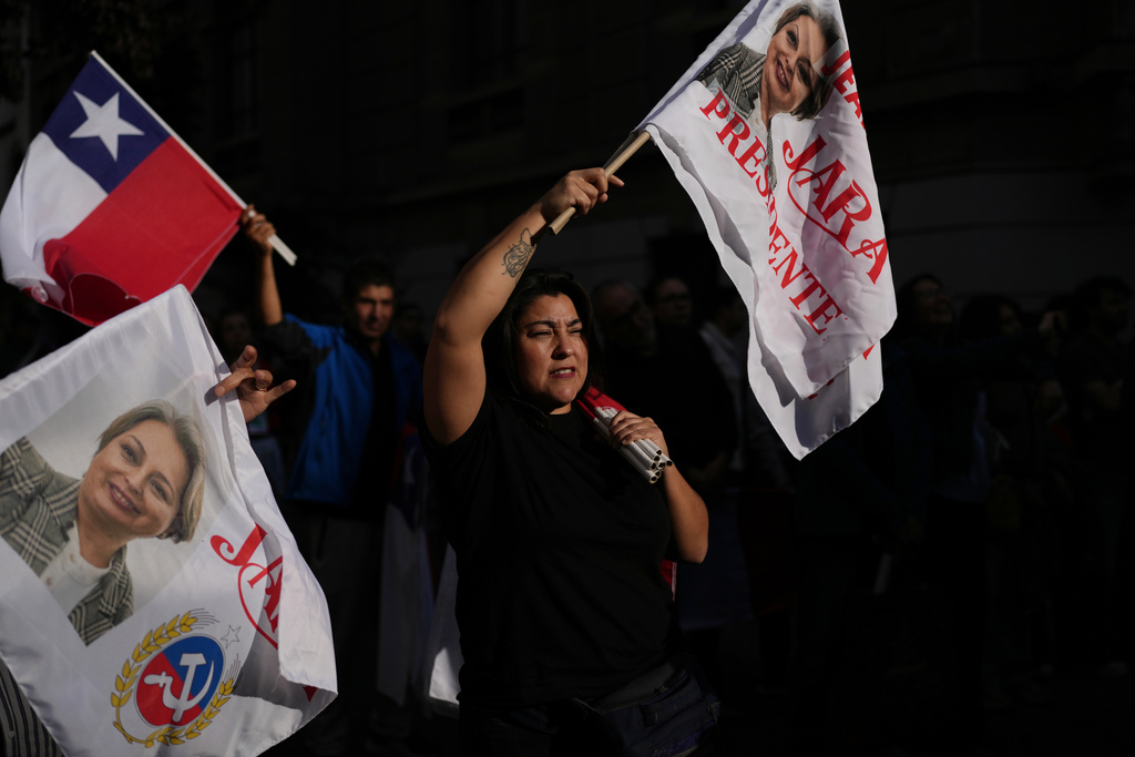 Supporters gather at the campaign headquarters of Jeannette Jara, presidential candidate of the ruling Unity for Chile coalition, after polls closed for the presidential runoff in Santiago, Chile, Sunday, Dec. 14, 2025. (AP Photo/Natacha Pisarenko)