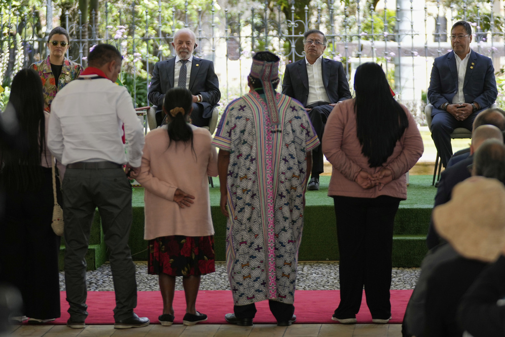 From left back, Ecuador's Vice President Maria Jose Ping, Brazil's President Luiz Inacio Lula da Silva, Colombia's President Gustavo Petro, and Bolivia's President Luis Arce meet with Indigenous leaders during a summit of leaders of the Amazon Cooperation Treaty Organization in Bogota, Colombia, Friday, Aug. 22, 2025. (AP Photo/Fernando Vergara)
